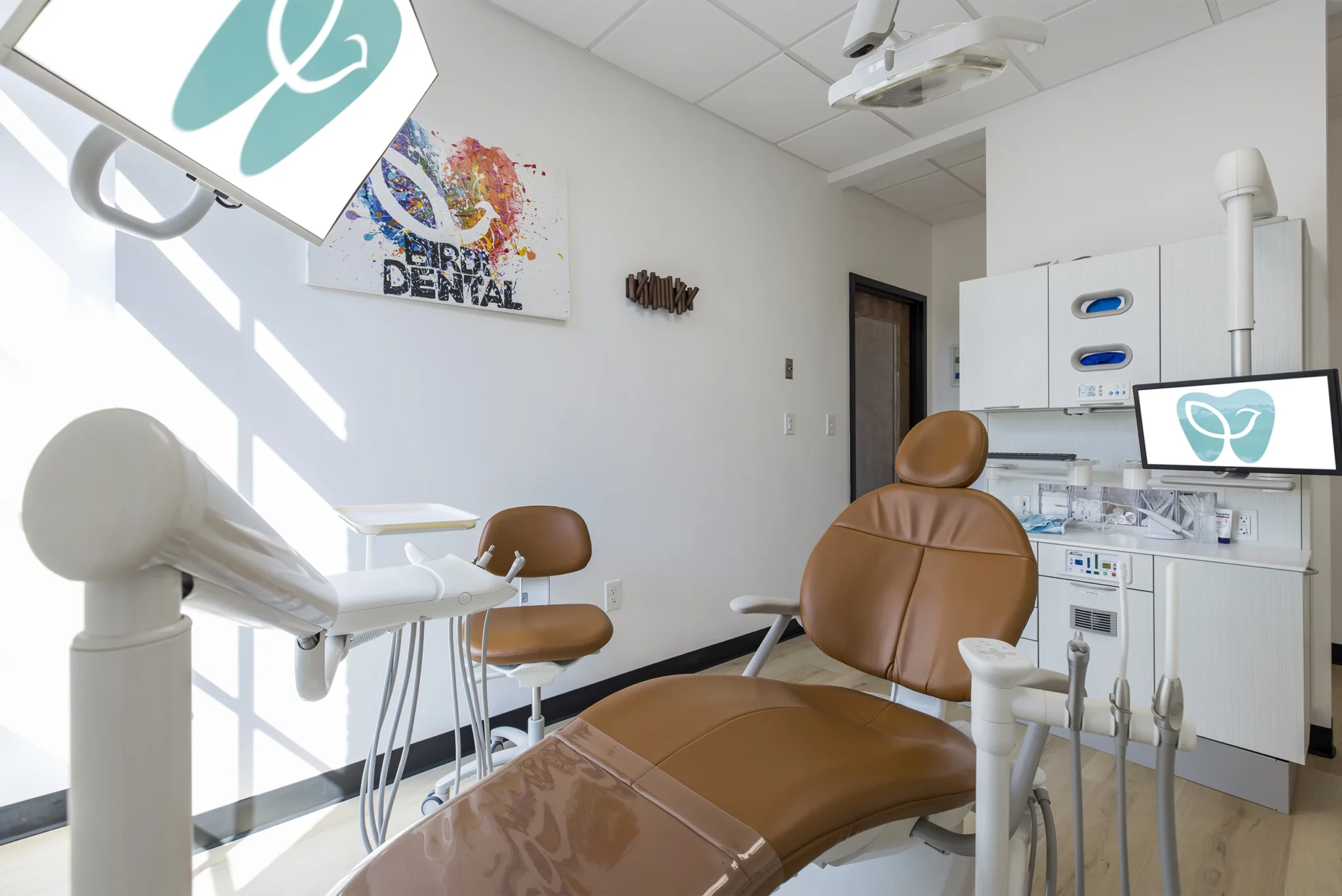 Nobody in clean modern dentists office: leather dental chair and operator stool, dental operating light, dental equipments for treatment
